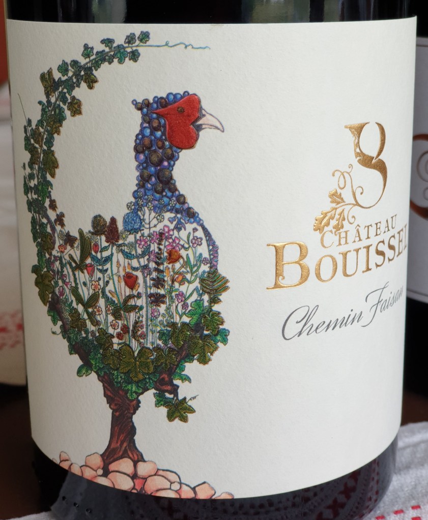 Chemin Faisan, 2014, assemblage de Negrette Syrah Malbec Sur l'etiquette un faisan qui vit dans le domaine, avec un trompe l'oeil sur un pige de negrette, le raisin au milieu et les fleurs de printemps pour expliquer le renouveau de la reprise du Domaine Buissel
